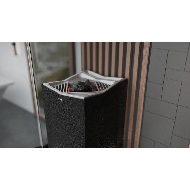 Tylö Crown Combi Saunaofen mit schwarzem Korpus, silbernem Deckel und gefüllten Saunasteinen in modernem Badezimmer
