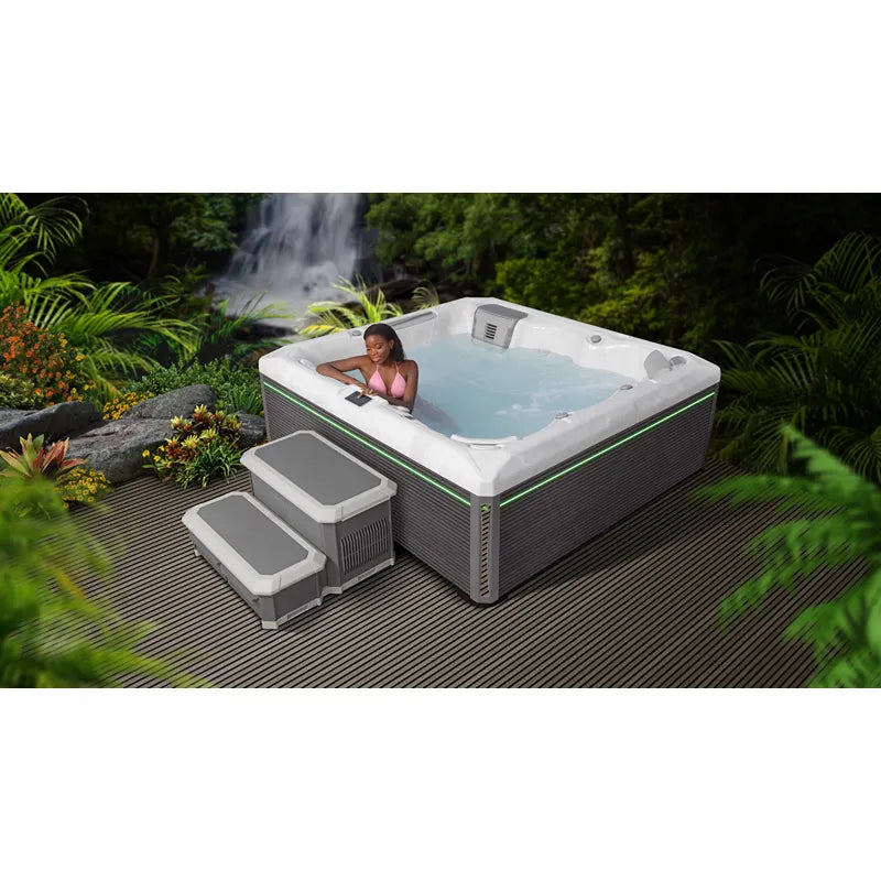 Wellis Atlas Life Premium Whirlpool mit 6 Sitzen und 43 Jets im tropischen Garten mit Wasserfall
