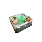 Wellis Budapest Life Premium-Whirlpool mit zwei Personen im grün beleuchteten Wasser, modernes Design mit dunklem Holzsockel