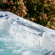 Wellis Everest Life Premium Whirlpool mit aktivierten Wasserjets und sprudelndem Wasser im Garten
