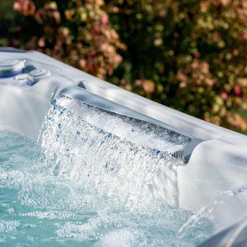 Wellis Everest Life Premium Whirlpool mit aktivierten Wasserjets und sprudelndem Wasser im Garten