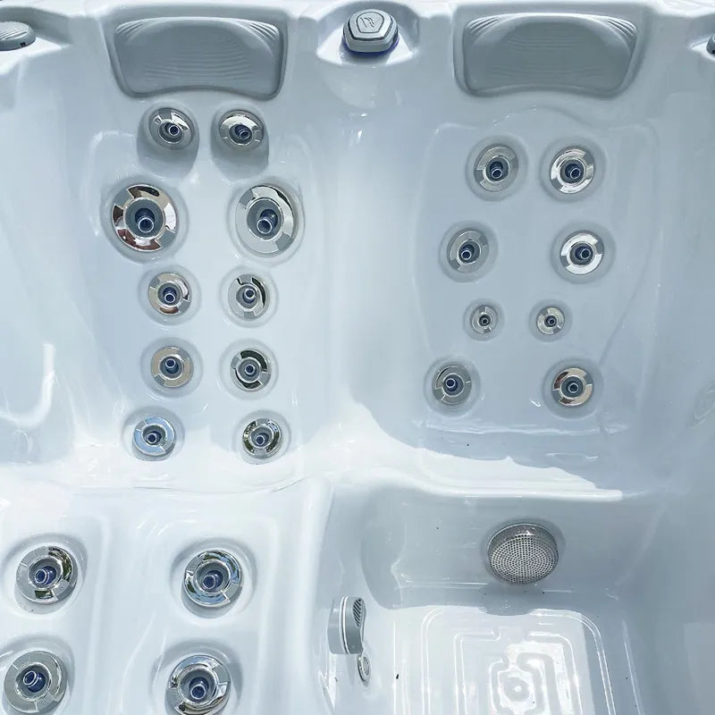 Wellis Manhattan Life Hot Tub interior from above with white basin, headrests, and numerous massage jets